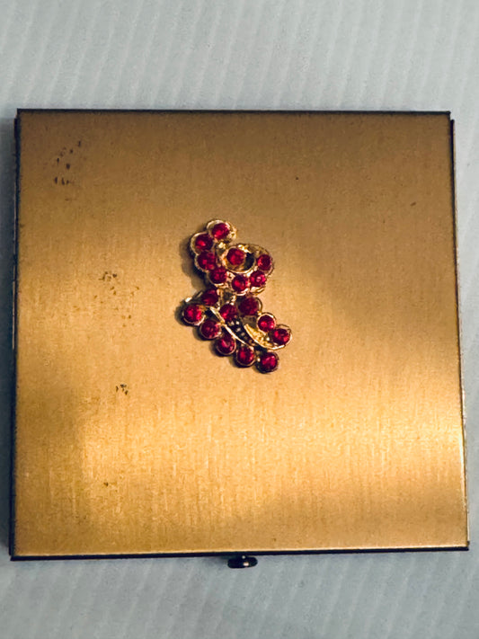 Beautiful 1940s Dorset make up compact with red rhinestone detailing on the top. Never been used.