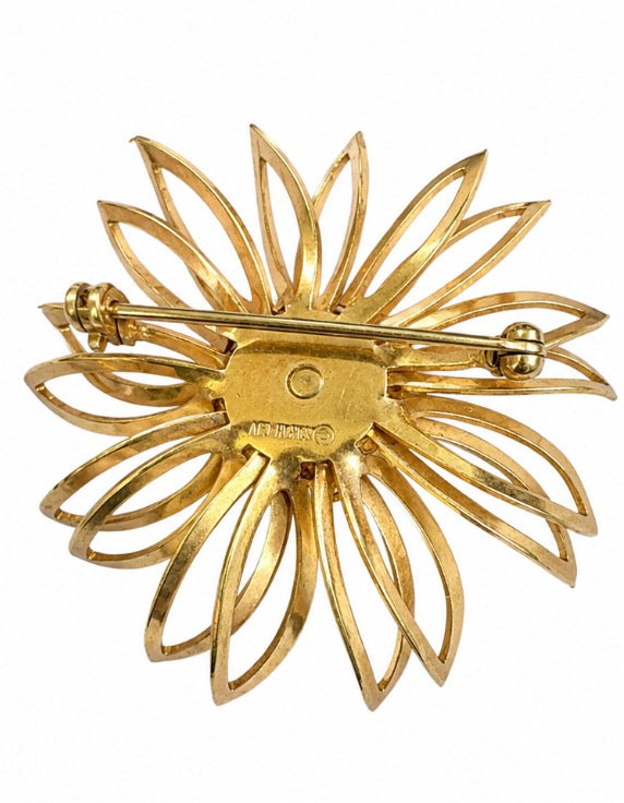 1970s signed SARAH Coventry gold tone flower brooch with red rhinestone center