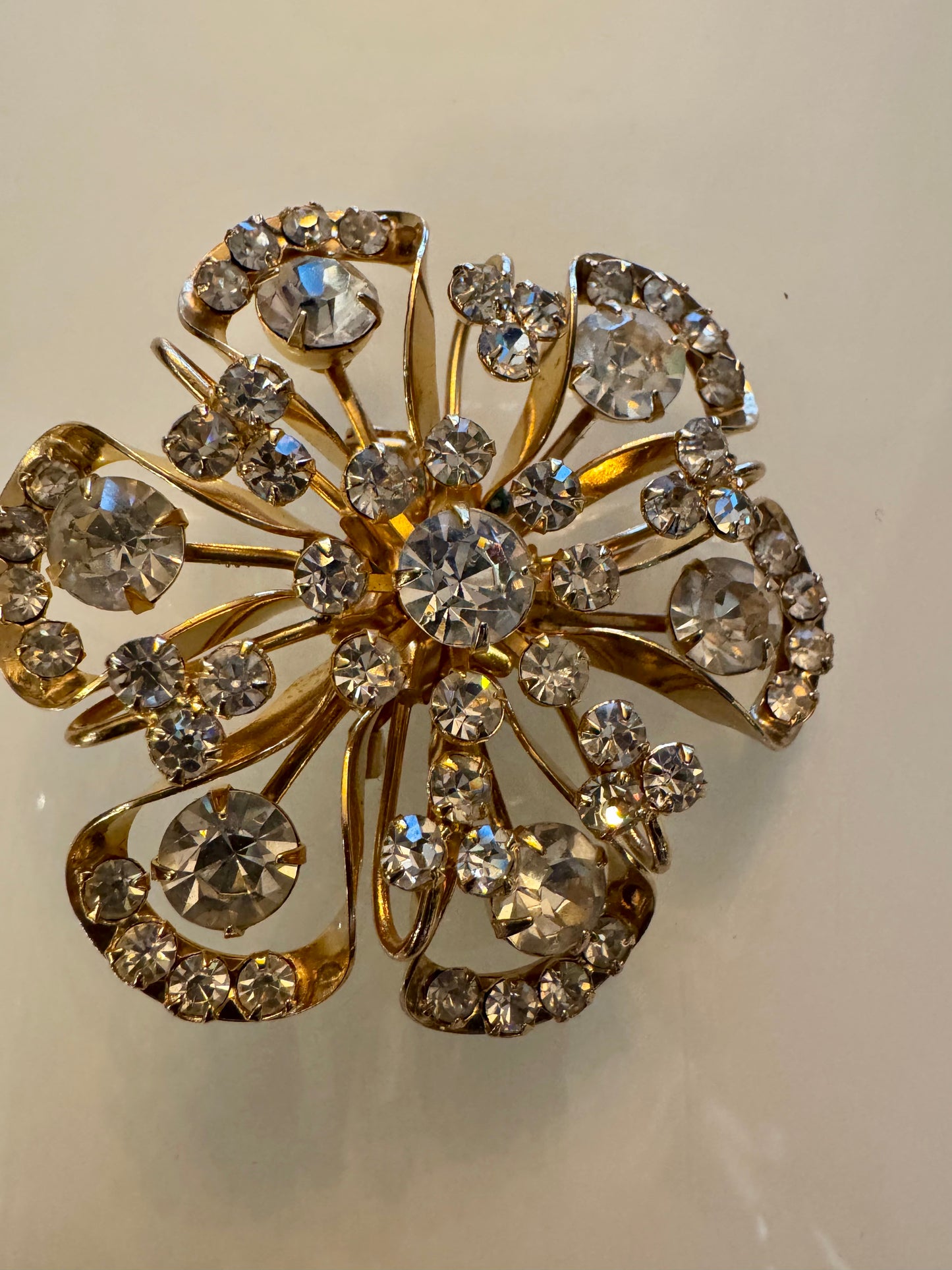 Elegant 1950s gold tone and rhinestone flower brooch