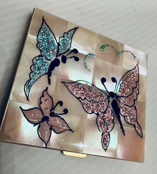 Stunning mother of pearl with painted rhinestone butterfly design makeup compact. Never been worn.