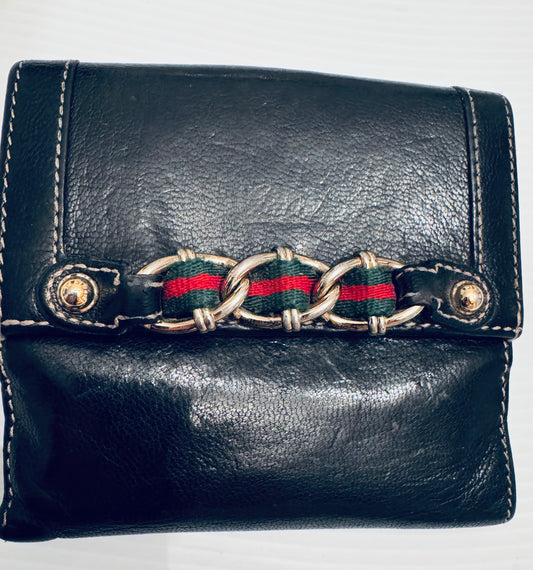 Vintage black leather Gucci wallet with gold tone and ribbon detail