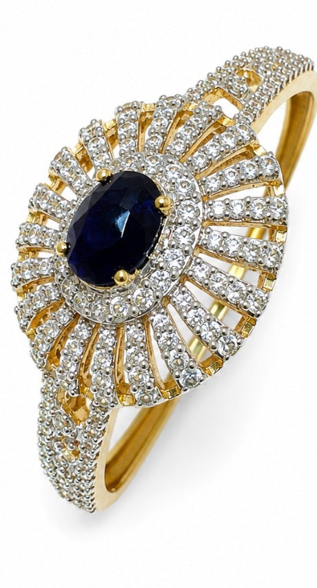 Beautiful vintage clamper bracelet with clear rhinestones and sapphire colored center stone.
