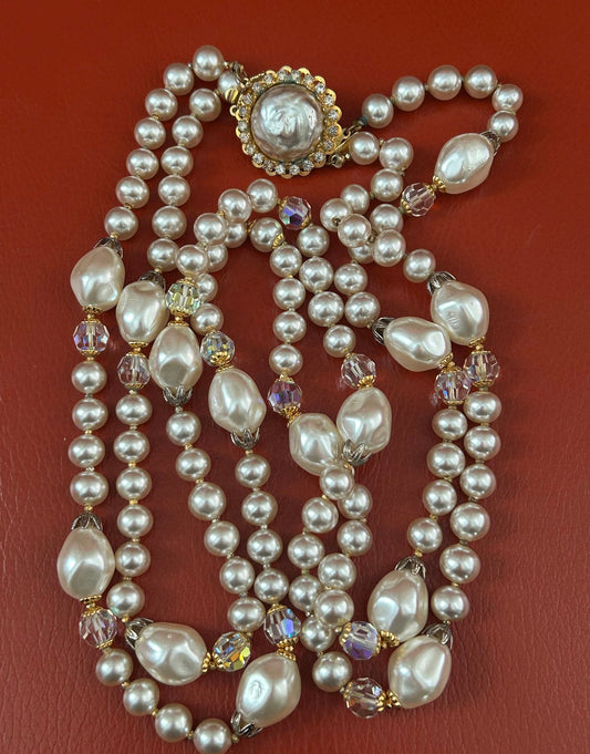 1940s vintage necklace by Hattie Carnegie. This stunning necklace has beautiful round champagne colored faux pearls with gold spaces between each one. It also has larger mabe pearls throughout accented with faceted ab crystal rhinestones.