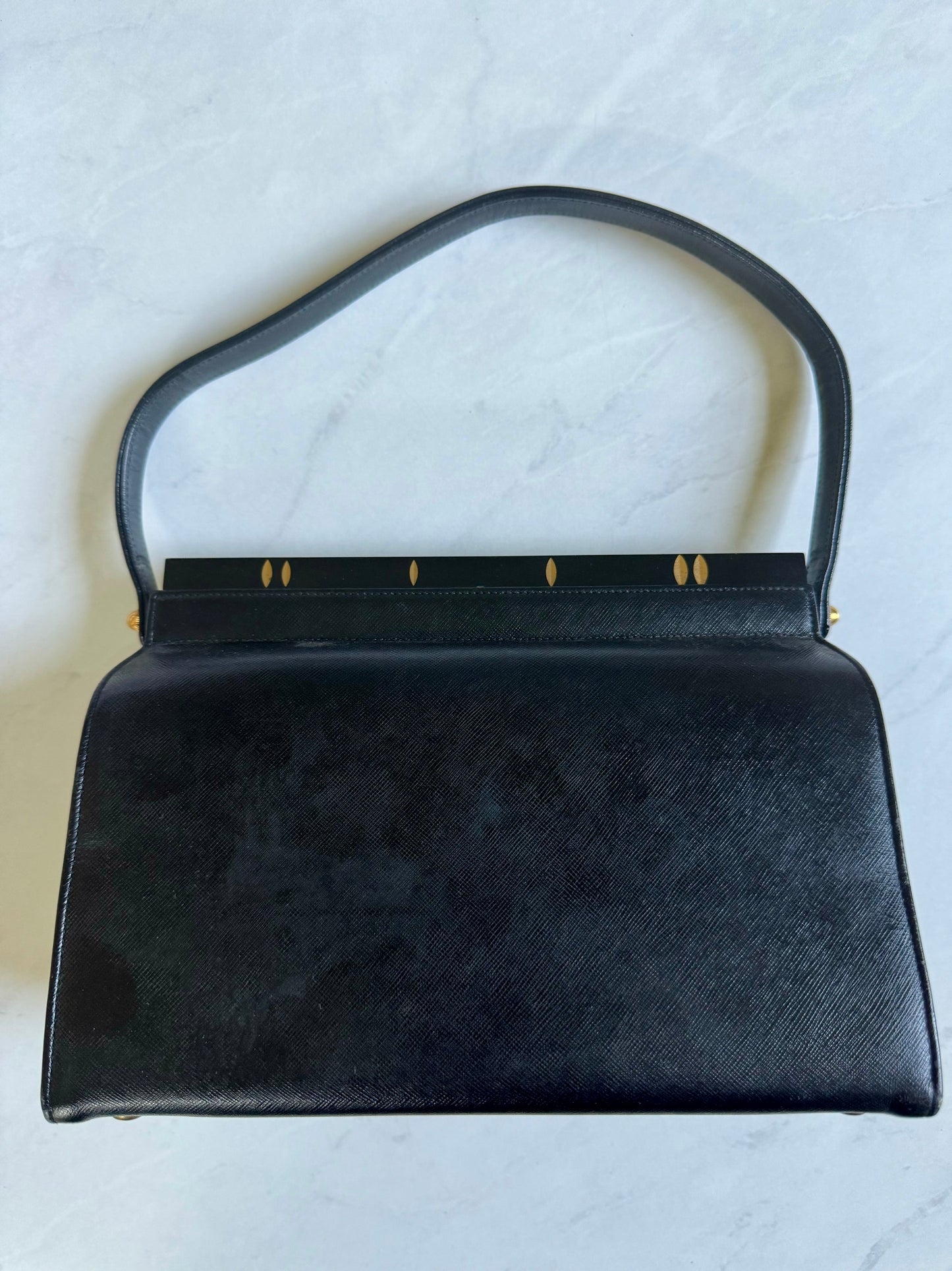 Gorgeous 1950s black leather bag with black lucite and gold top hardware