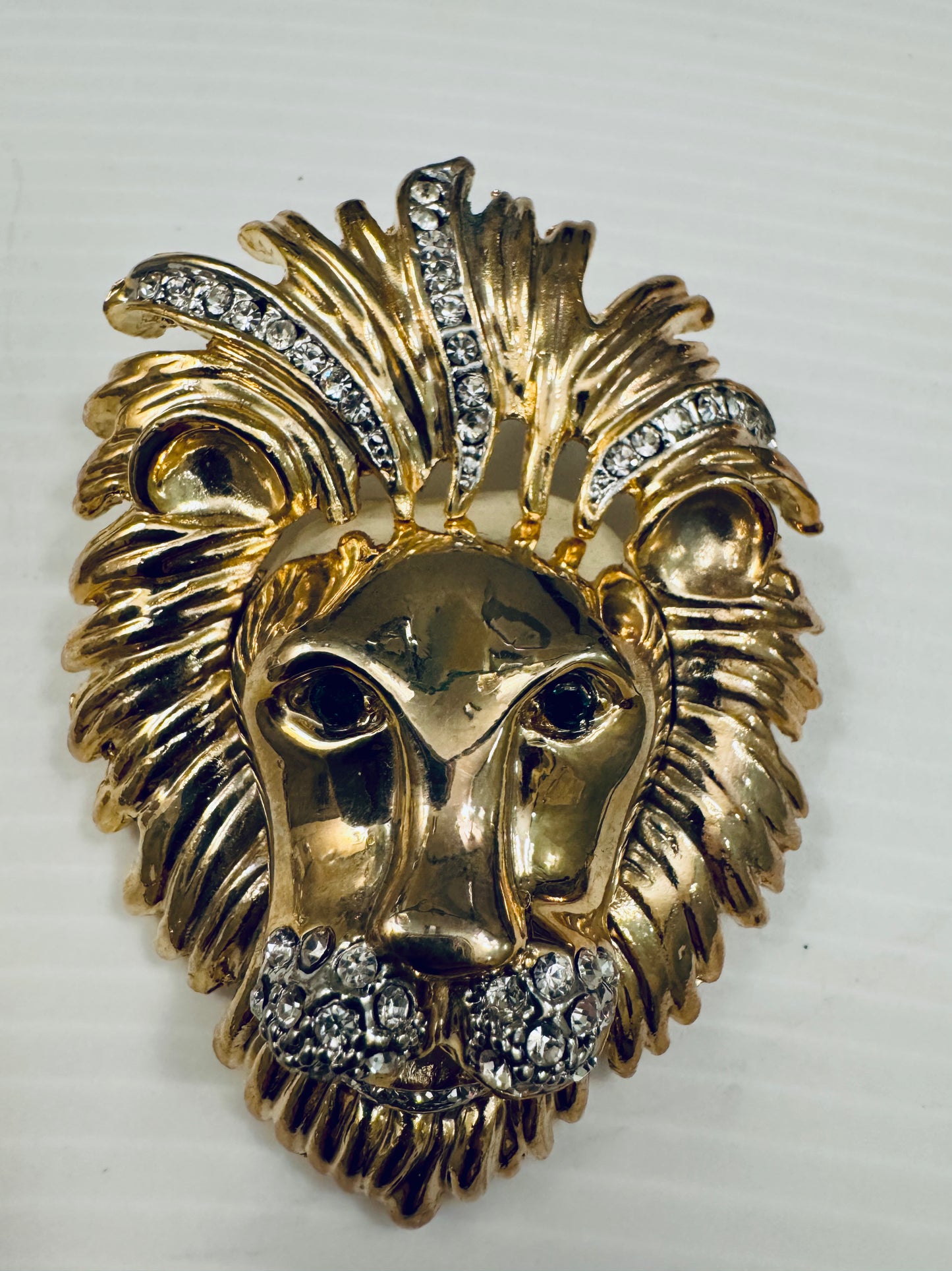 Jumbo 1980s goldtone lion head brooch with green and clear rhinestones