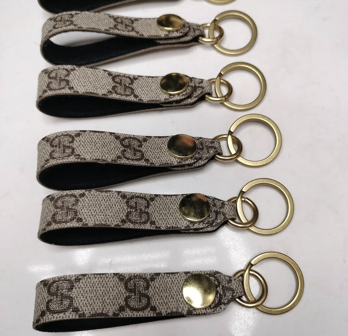 Upcycled authentic Gucci key rings. Choose red or black backing. Brass hardware.