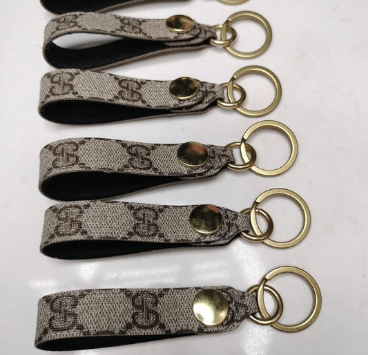 Upcycled authentic Gucci key rings. Choose red or black backing. Brass hardware.