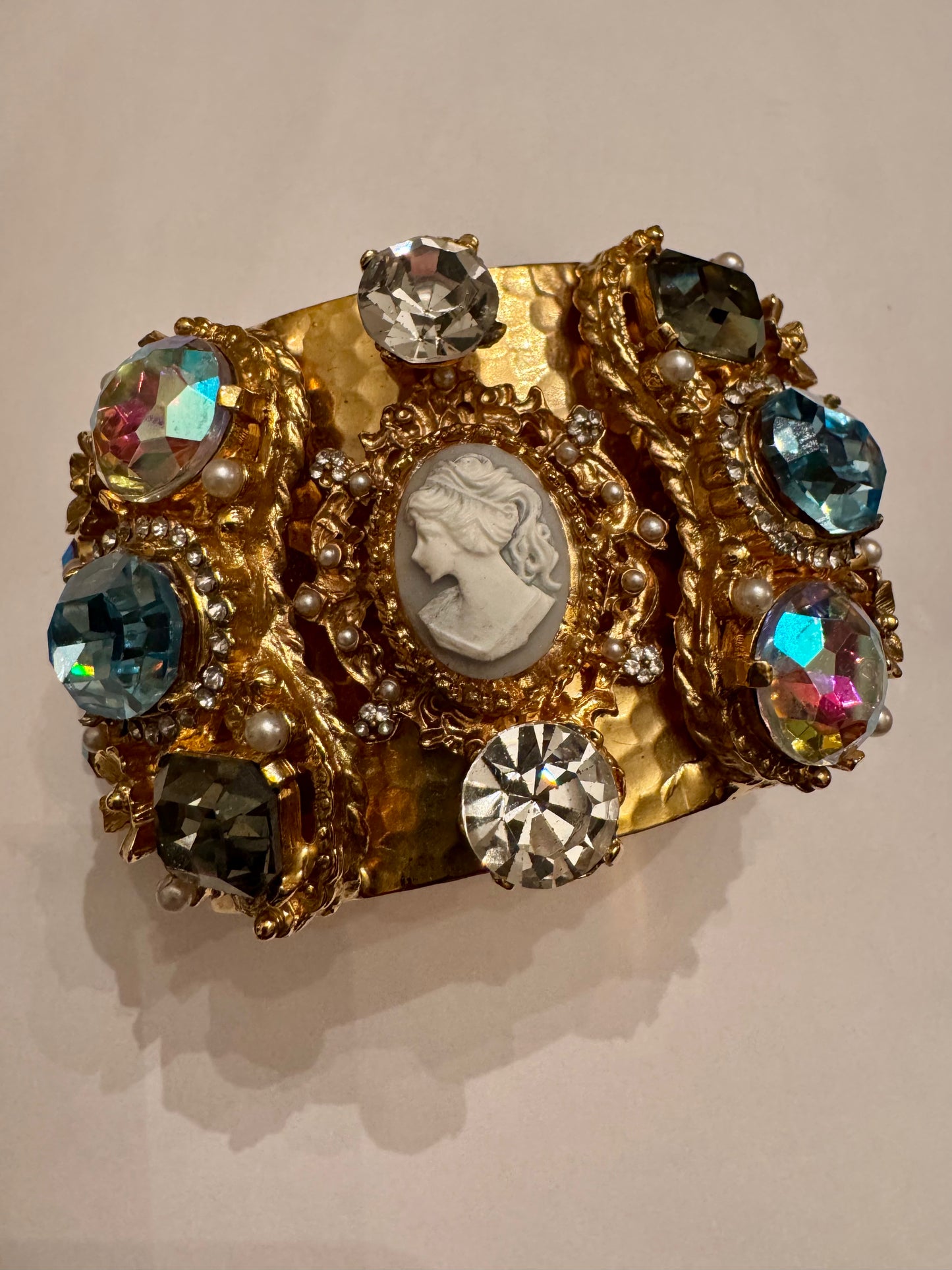 1980s incredible vintage cameo bracelet on hammered gold tone cuff, featuring rhinestones, aurora borealis and faux pearls