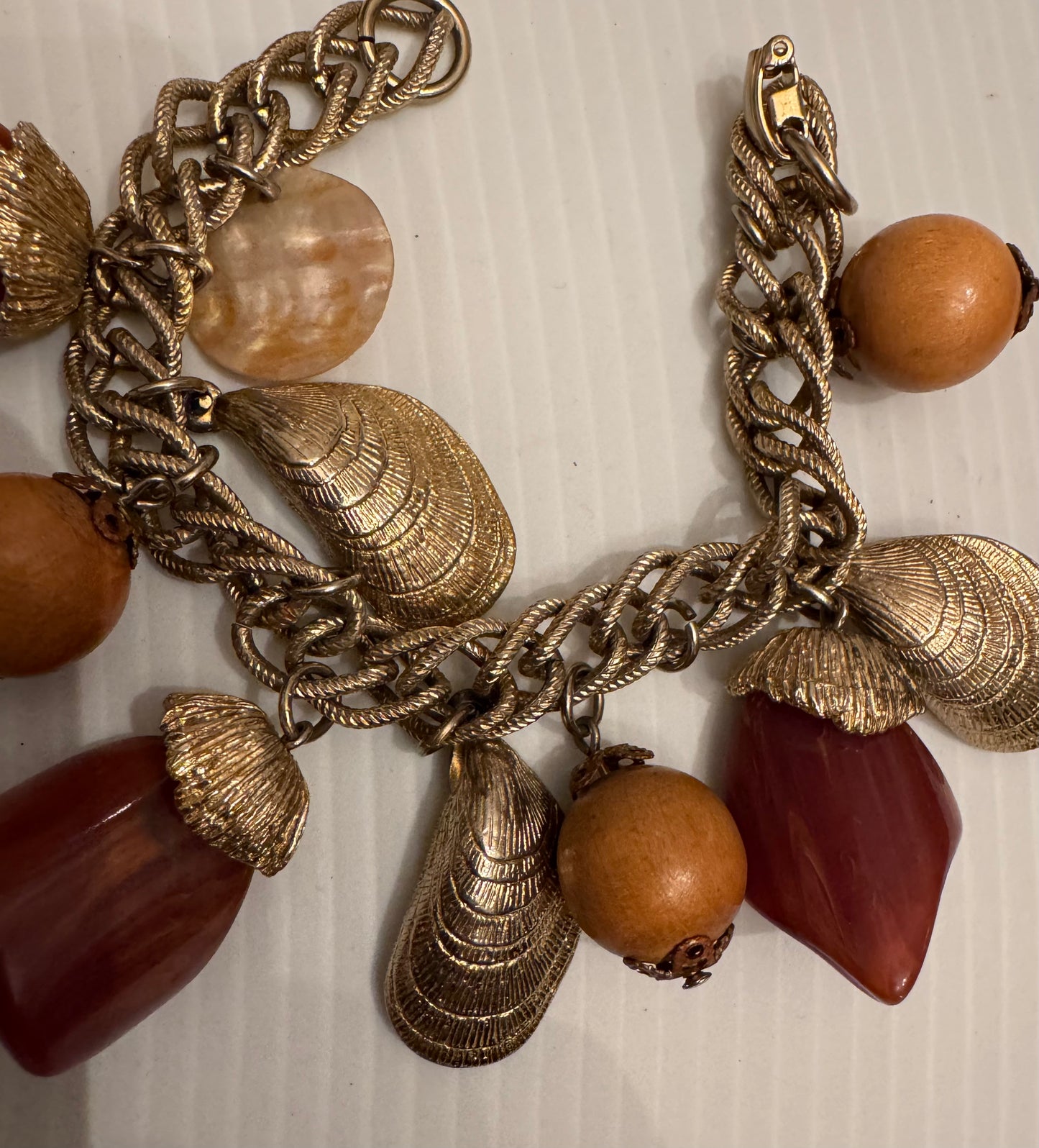 1970s brown lucite and wood charm bracelet with shell charms