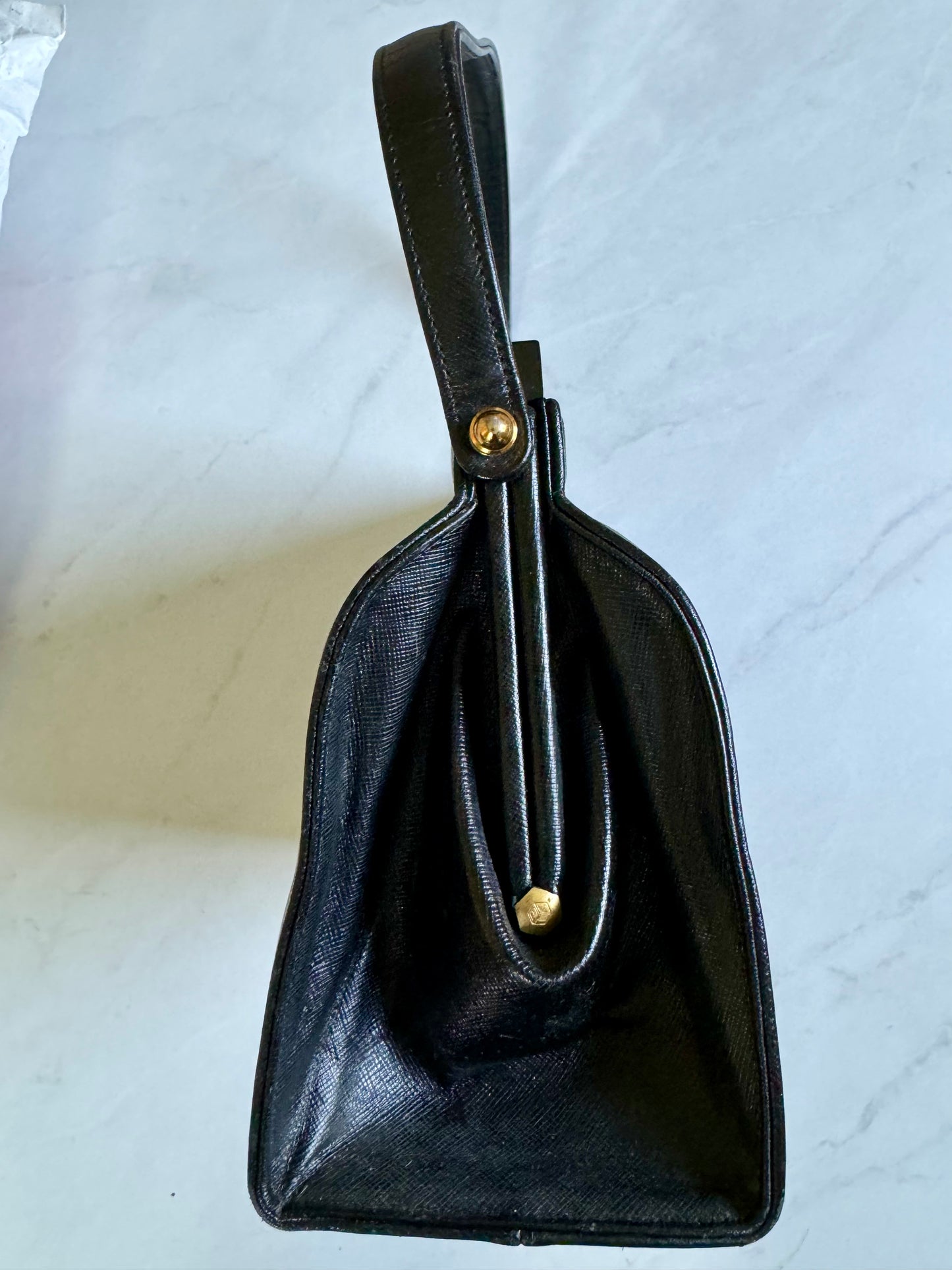 Gorgeous 1950s black leather bag with black lucite and gold top hardware