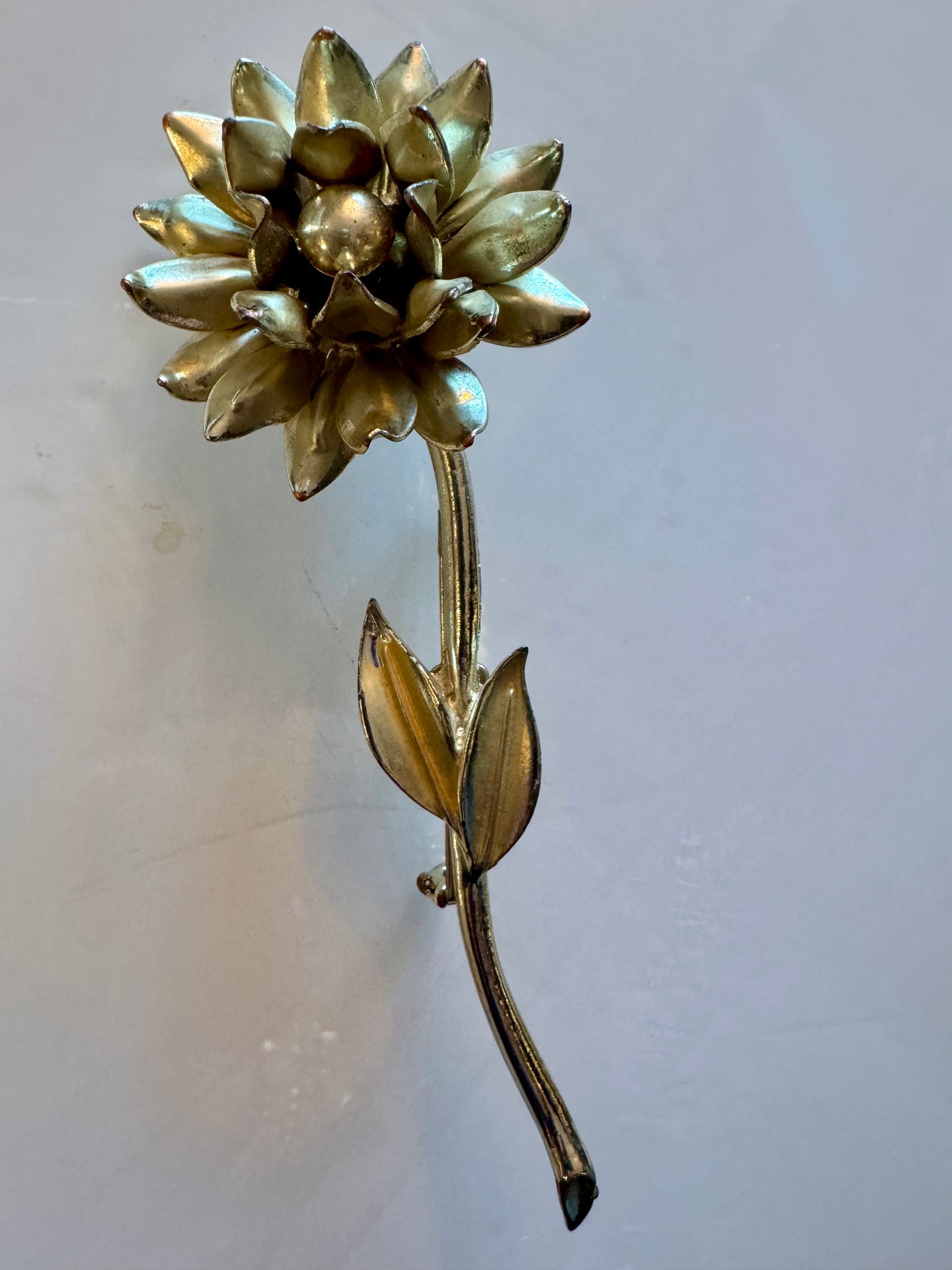 Gold tone vintage flower brooch with leaves and stem