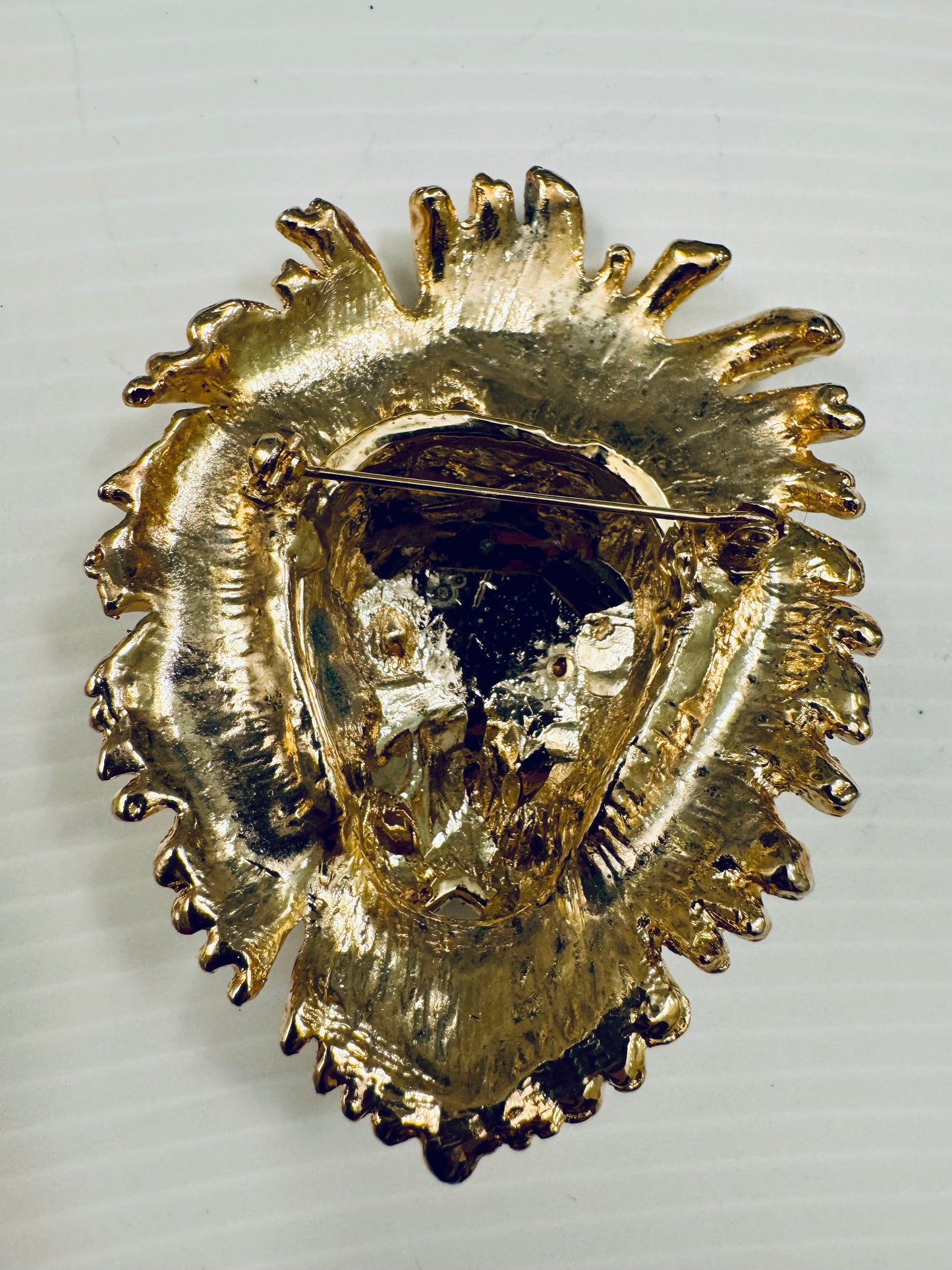 Jumbo 1980s goldtone lion head brooch with green and clear rhinestones