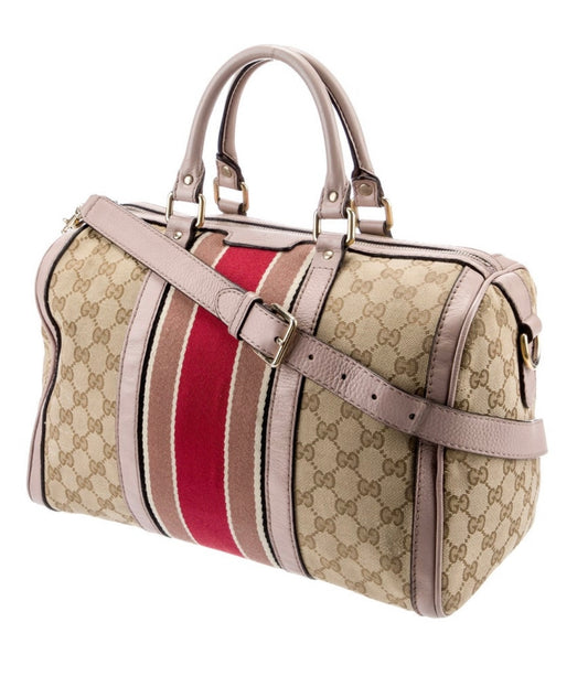 Gucci Boston Bag with leather handles and crossbody strap. 3 interior pockets.