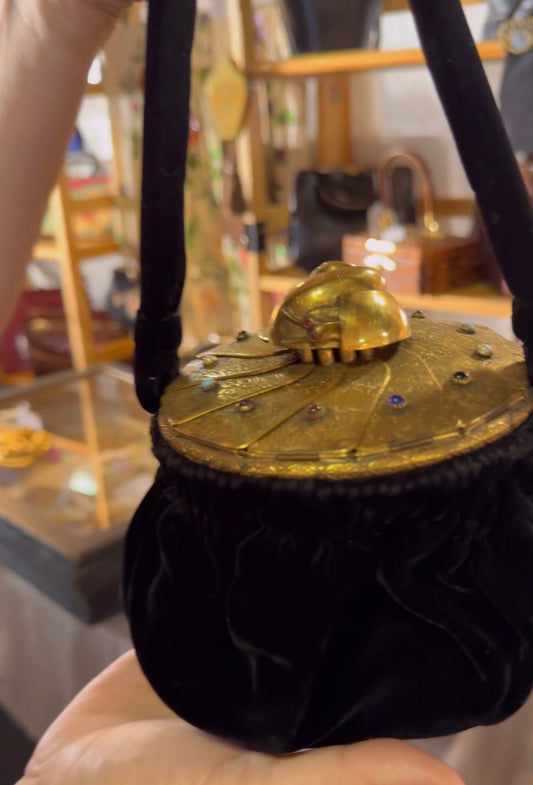 1940's one of a kind black velvet vintage wrist bag with shell top, gold tone tooled movable gate hardware and colored gem stones ~ circular mouth opening and silk interior.