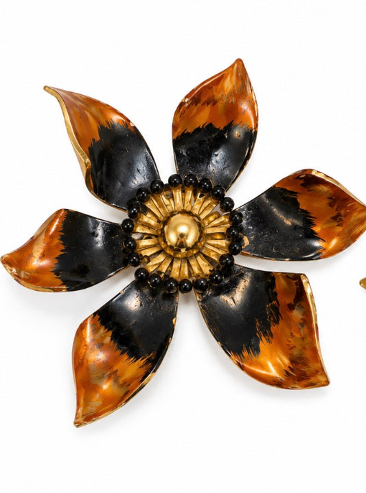 1970s flower brooch with black enamel and gold tone