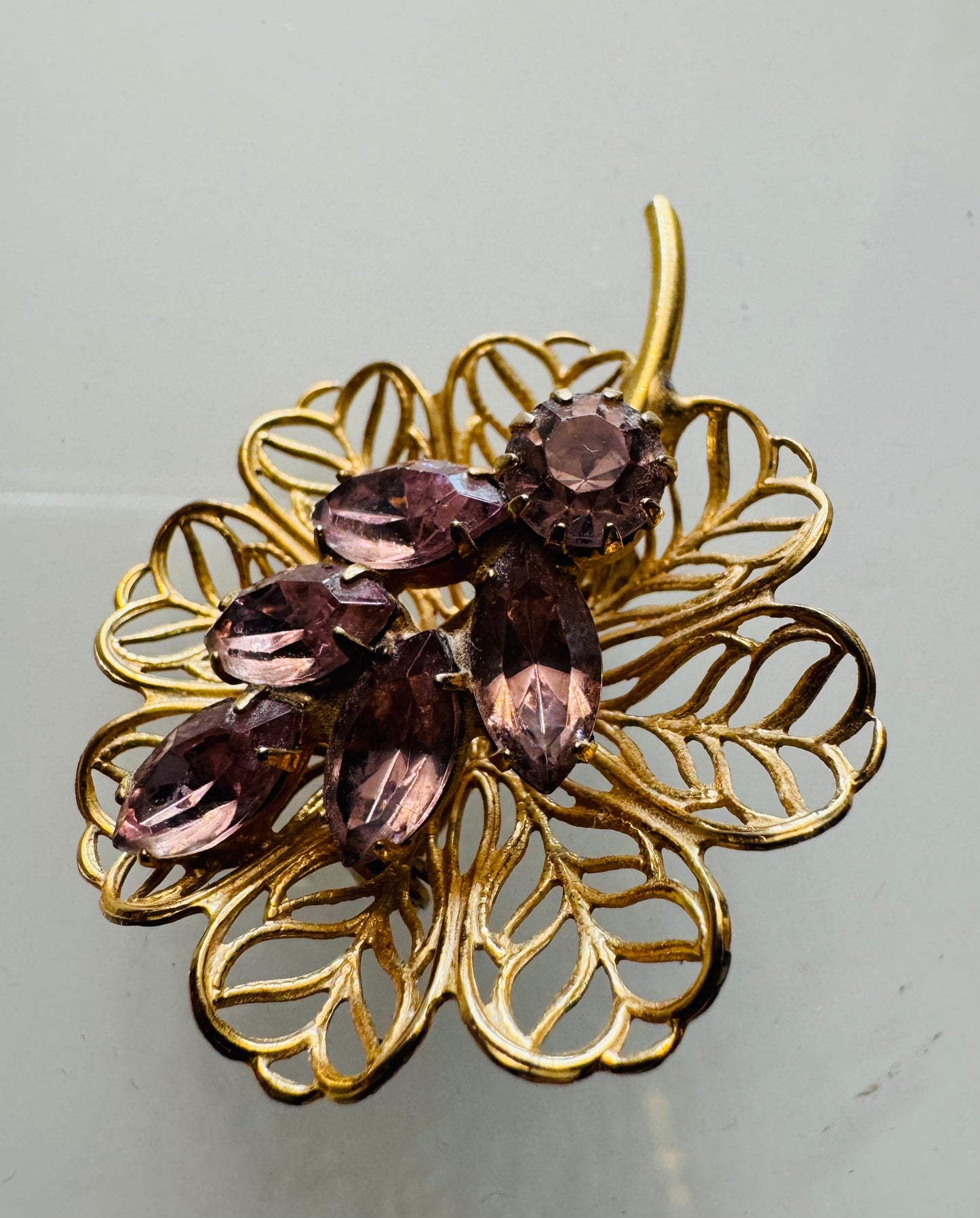 Mini gold tone filagree with flower brooch with light amethyst rhinestones