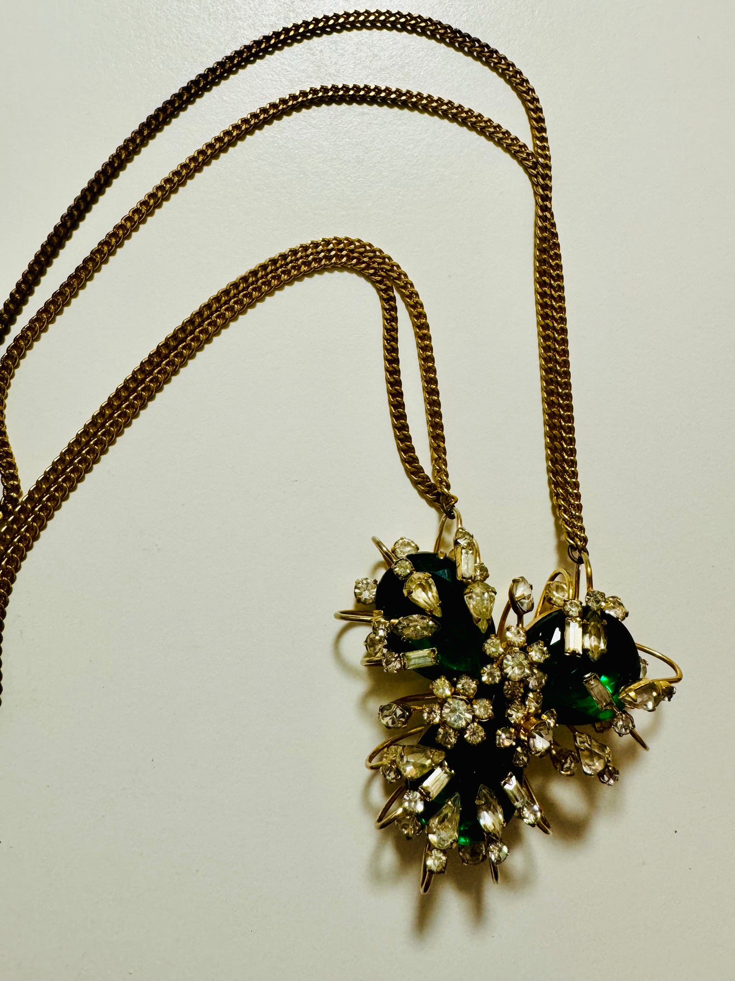 Gorgeous pendant / brooch necklace featuring green gemstone and rhinestones on a double gold tone chain