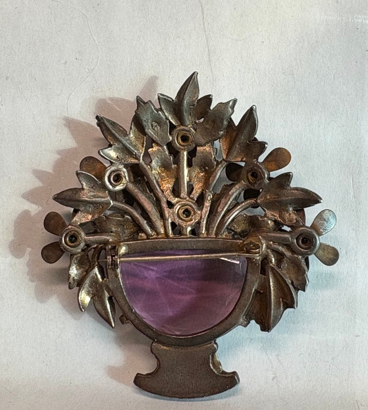 1940 gold guilded flowers with large amethyst matching glass stone. Unsigned book piece from All my Baskets by G.
Mariotti. Extremely rare and highly sought after.