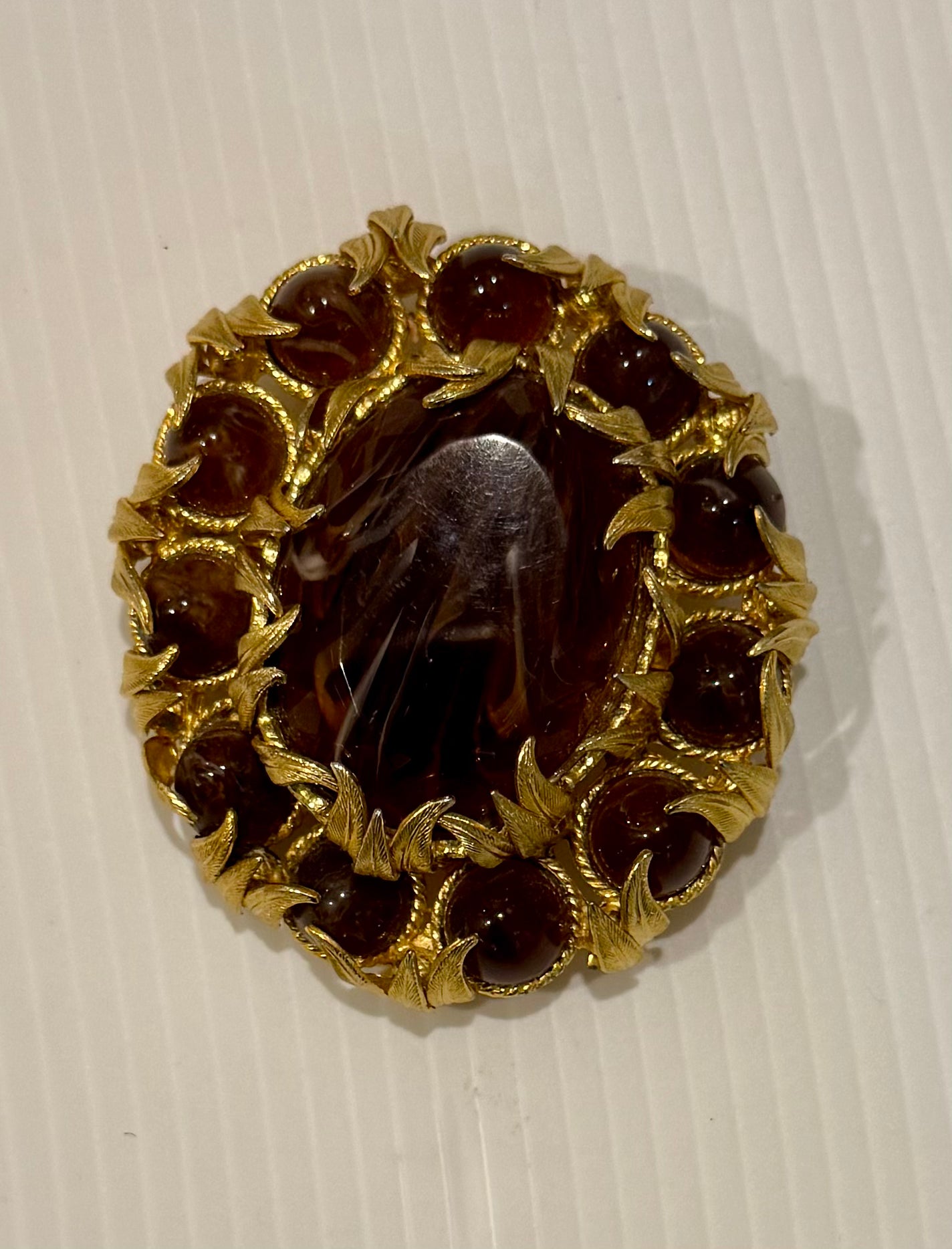 Jumbo gold tone brooch with amber colored stones