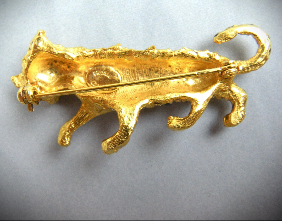 1960s Hattie Carnegie panther brooch features enameled stripes and crystal clear chatons.