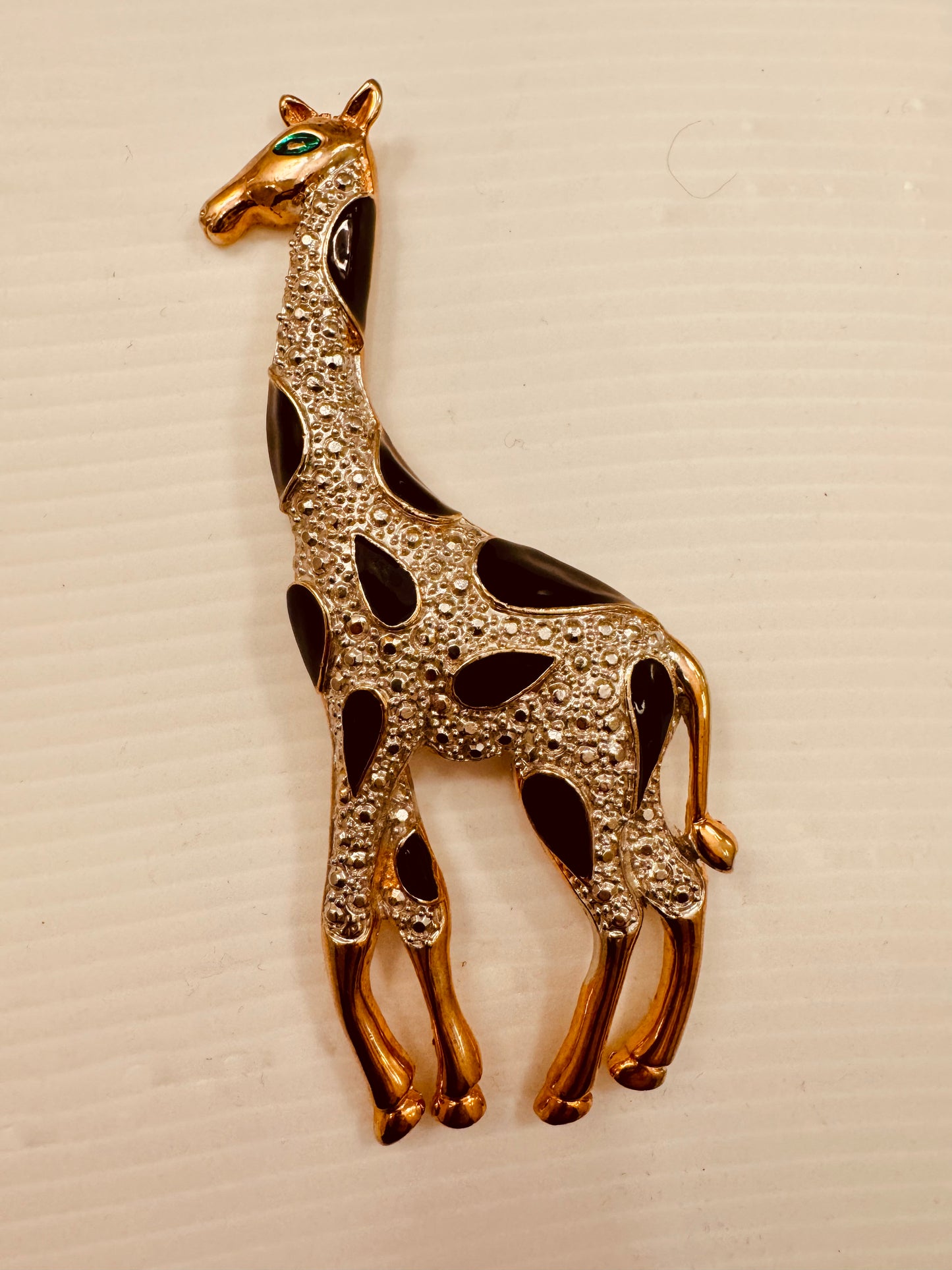 Jumbo 1980s gold tone giraffe brooch with black enamel, rhinestones and green eyes