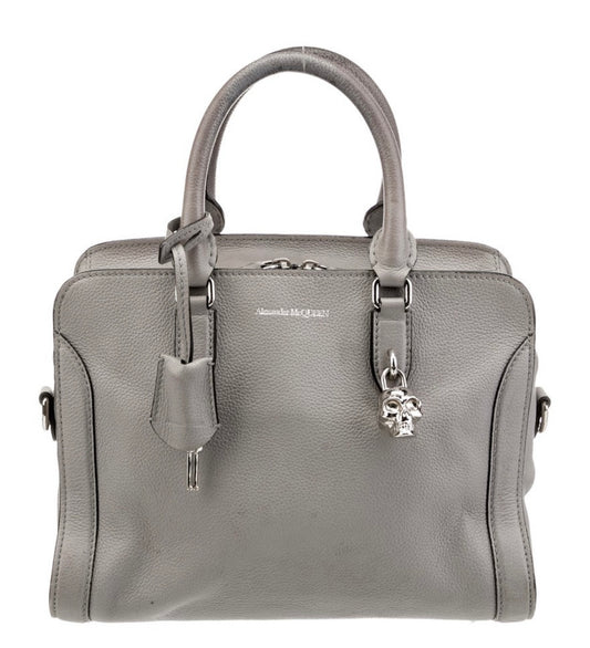 Vintage Alexander McQueen grey leather top-handle handbag with signature silver tone skull charm.