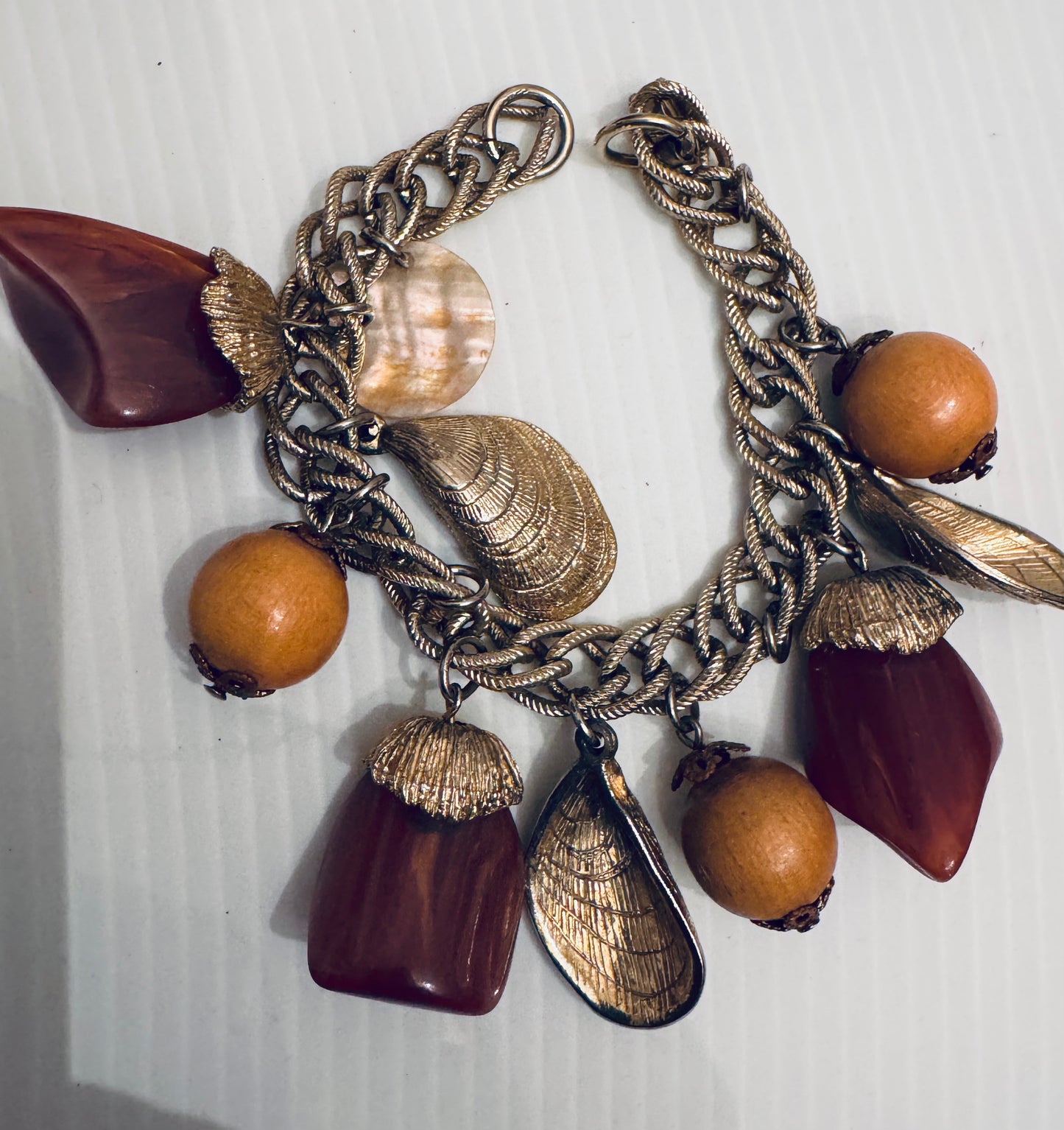 1970s brown lucite and wood charm bracelet with shell charms