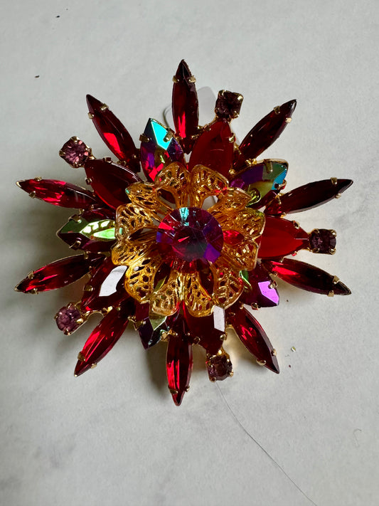 Gorgeous red and blue/green reflective rhinestone brooch with gold filigree center