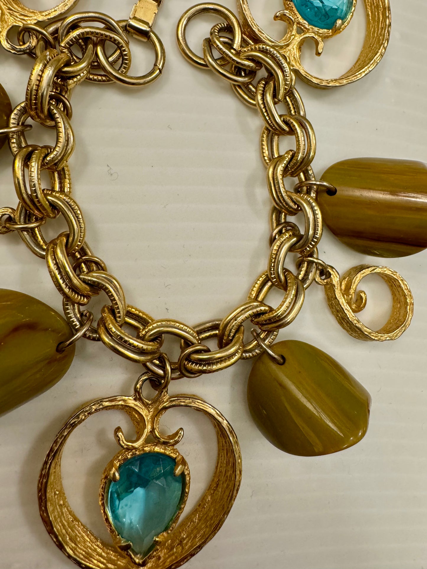 Jumbo 1970 gold tone charm bracelet with light blue charms and brown lucite beads