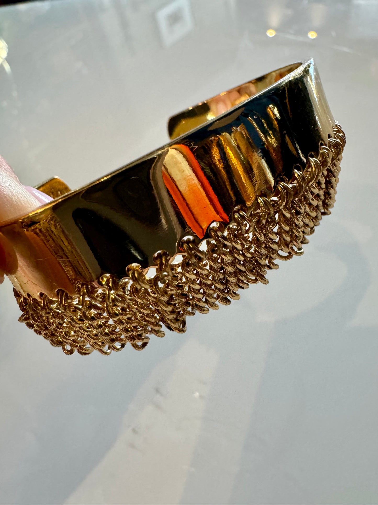 Gold tone adjustable bracelet with gold fringe detail