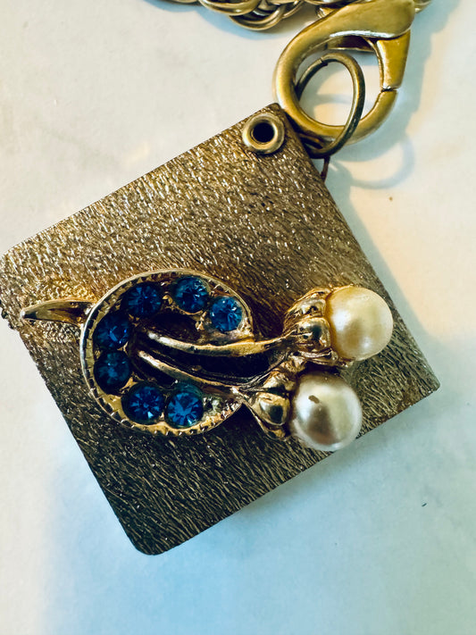 Vintage charm bracelet that opens into a mirror. Pearl and blue stones