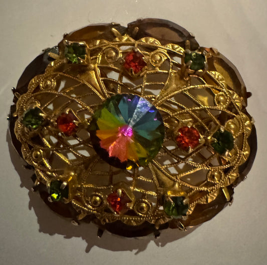 1950s Rivoli watermelon stone and filigree gold tone brooch. Note how center stone changes color in the light