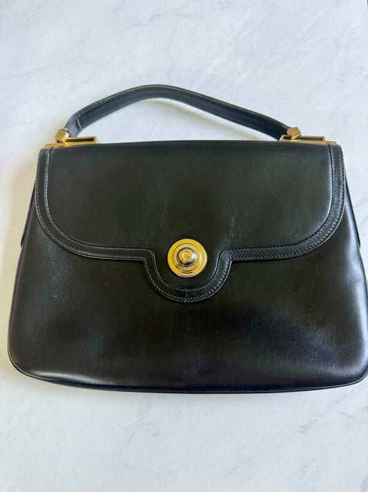 Vintage black 1970s leather Gucci top handle with  gold clasp and hardware. Don't hesitate because this Baby will be gone quickly!