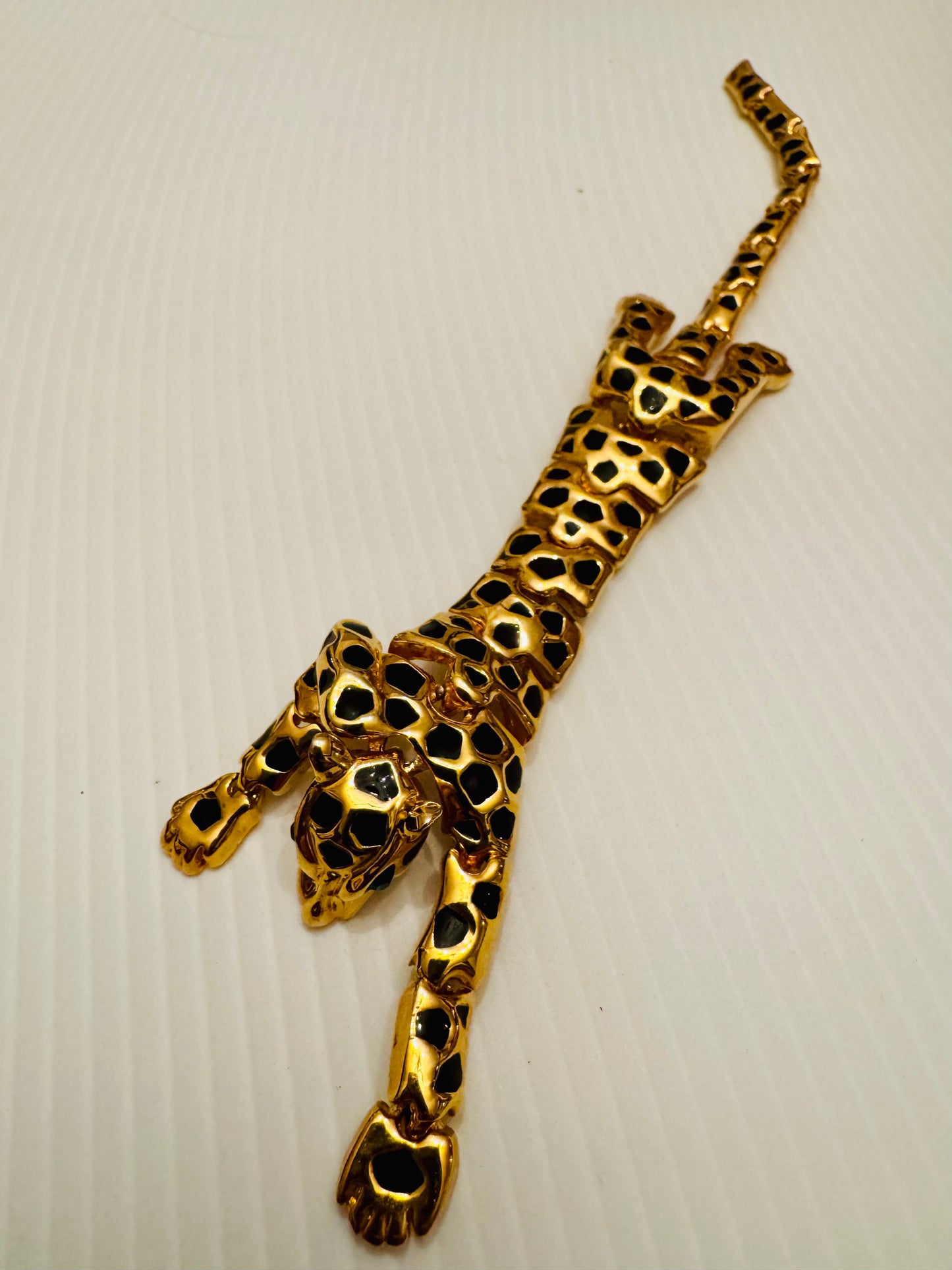 Extra long vintage gold tone cheetah and enamel shoulder brooch with green rhinestone eyes