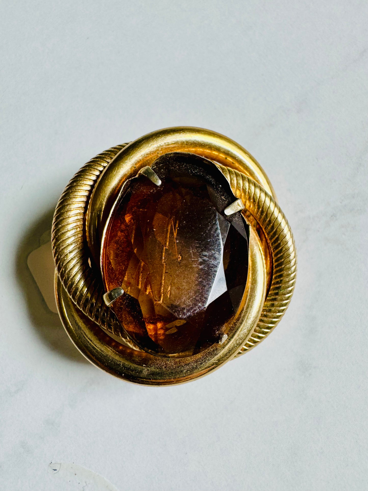 Amber and gold tone brooch