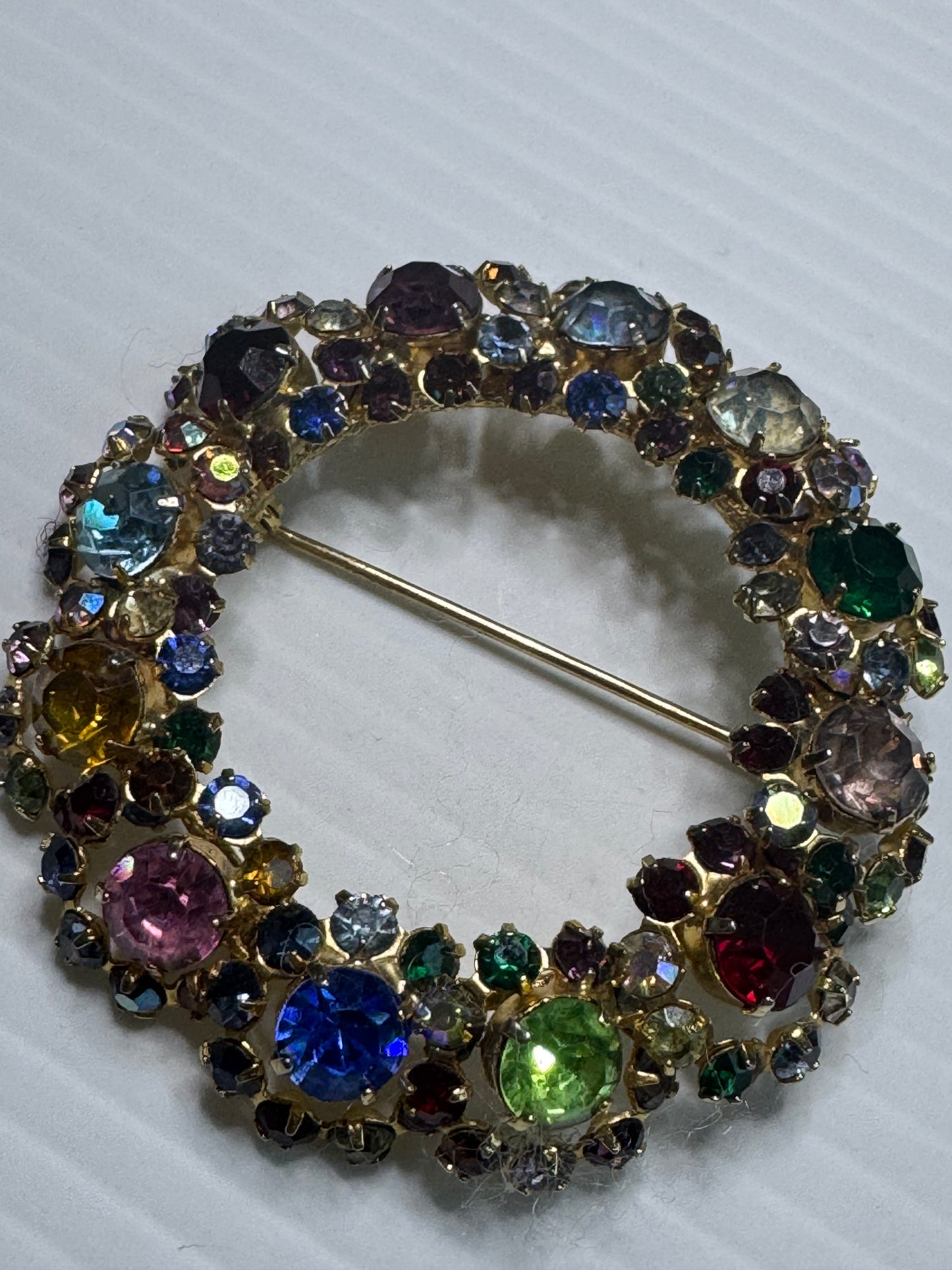 1940s unsigned, rainbow colored rhinestone wreath brooch