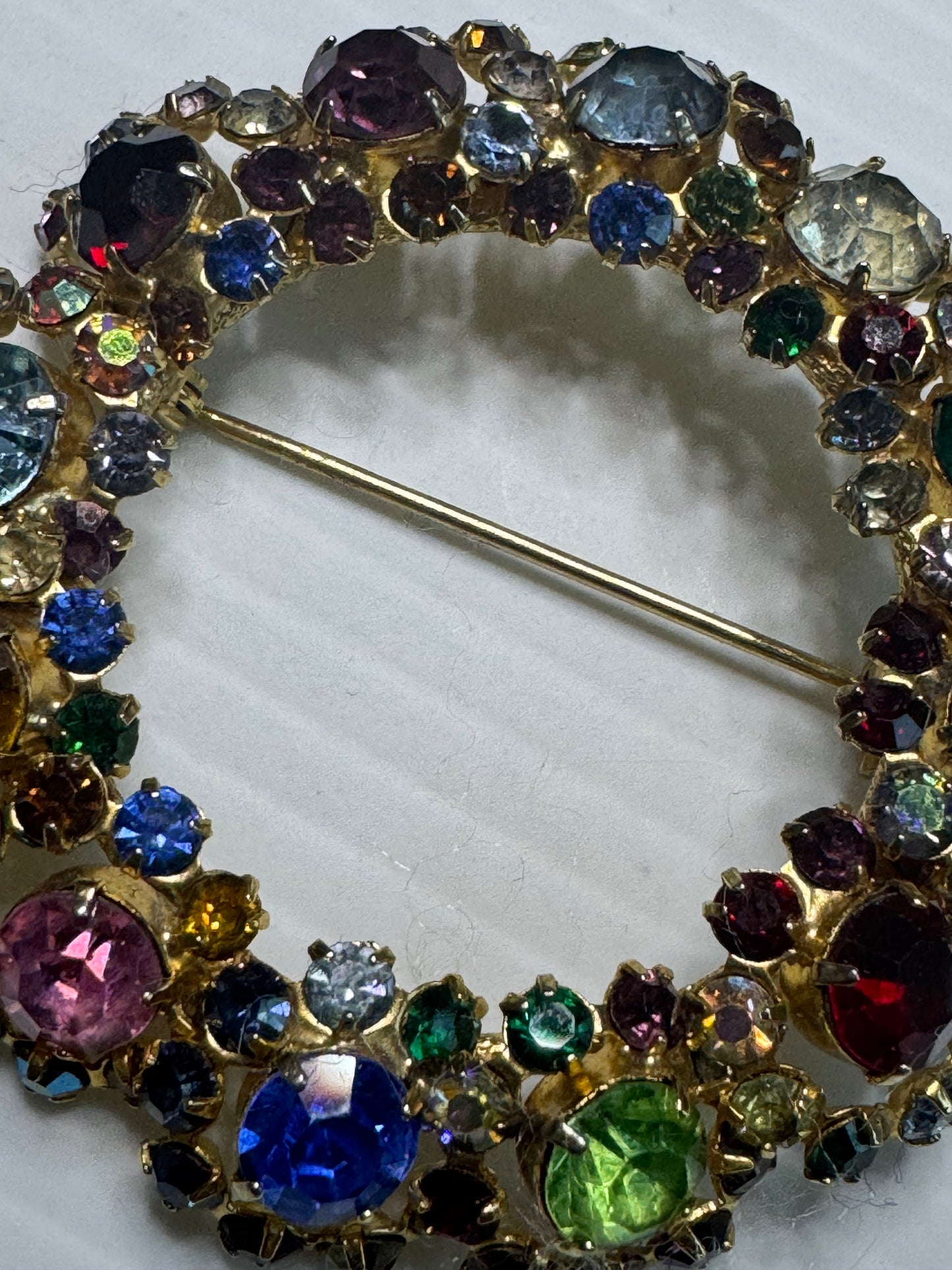 1940s unsigned, rainbow colored rhinestone wreath brooch