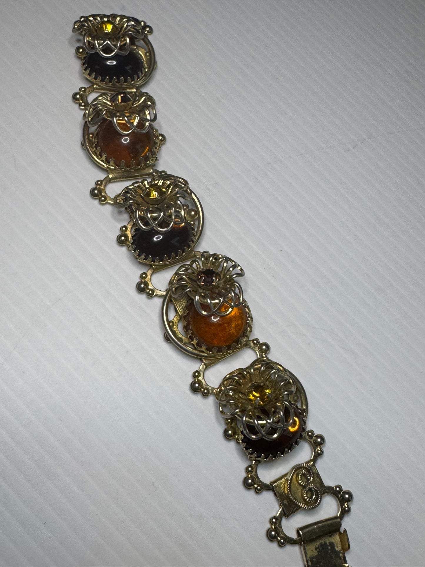 Beautiful 1940s 3-D cabochon and flower gold tone bracelet with amber colored rhinestones