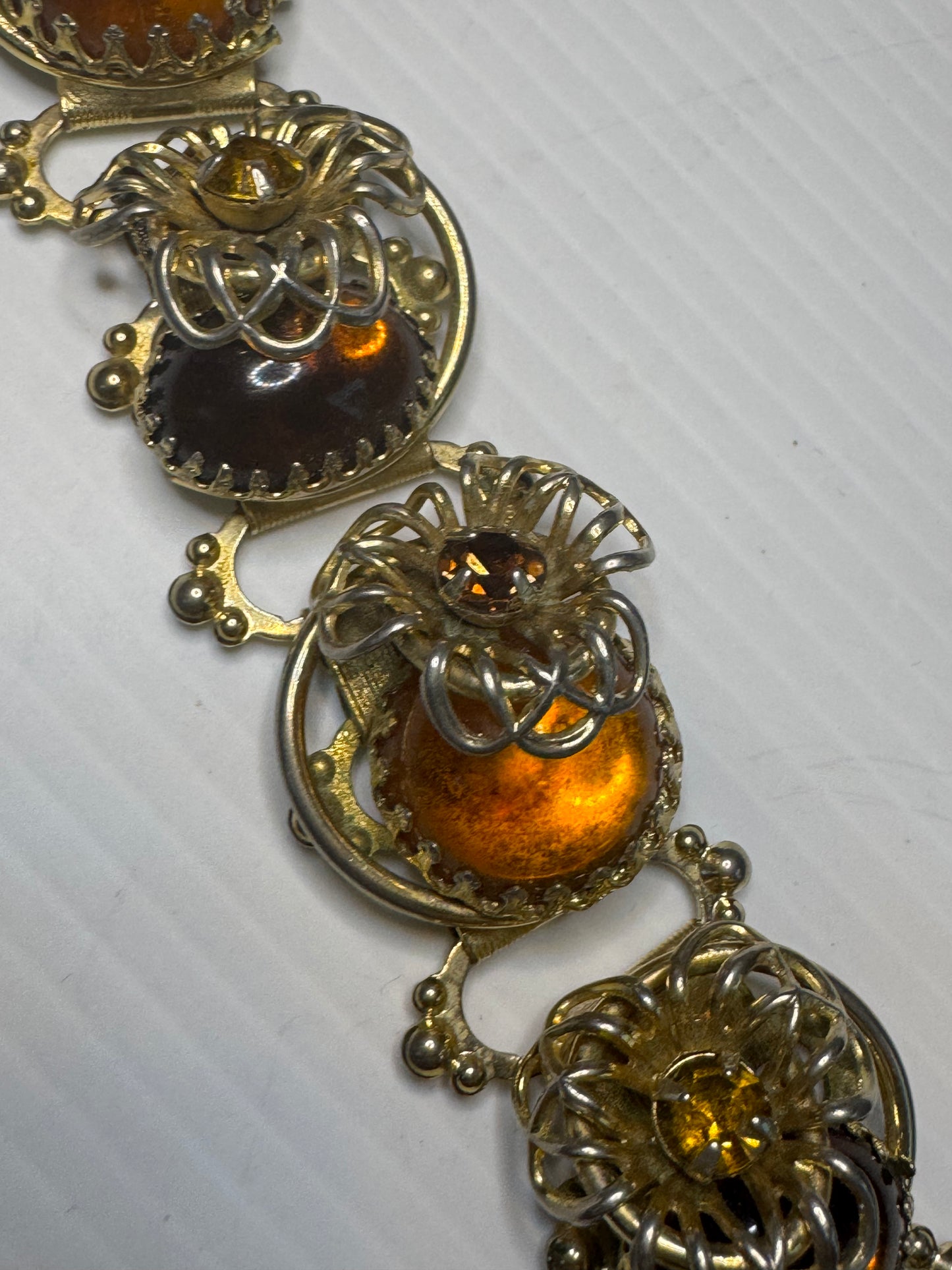 Beautiful 1940s 3-D cabochon and flower gold tone bracelet with amber colored rhinestones