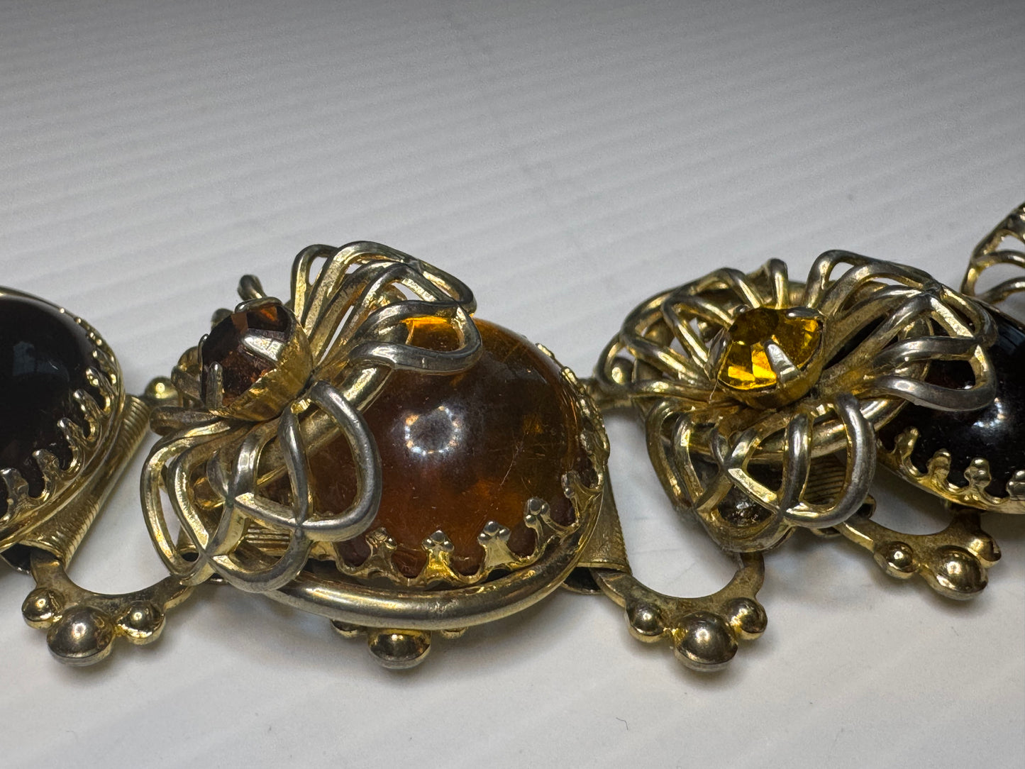 Beautiful 1940s 3-D cabochon and flower gold tone bracelet with amber colored rhinestones