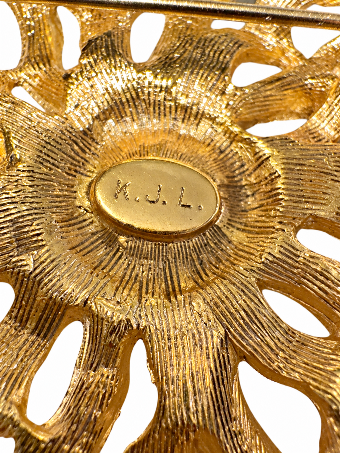 1970s signed KJL goldtone brooch with rhinestone and a pearl