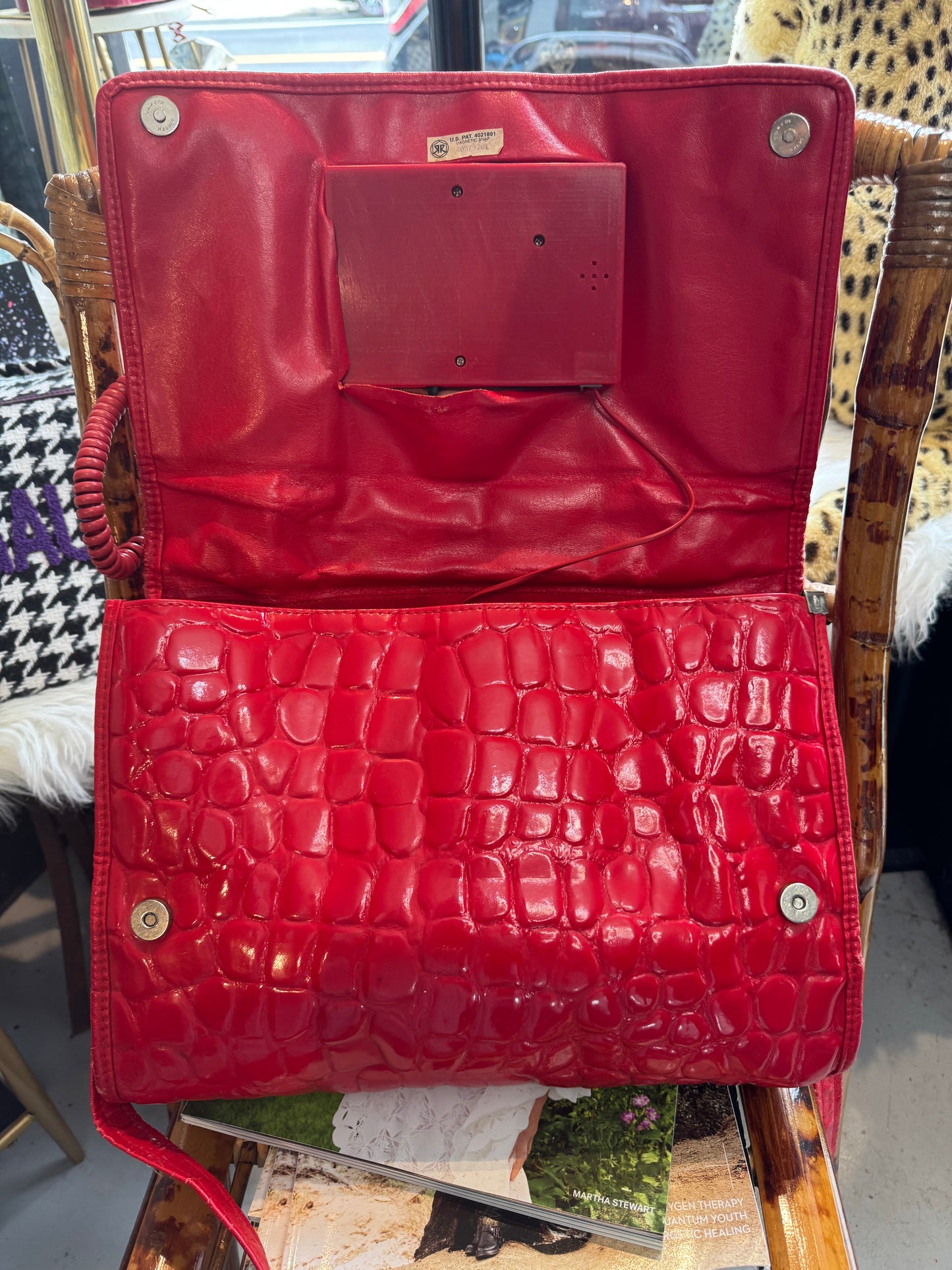 Vintage 1970s working (landline) red patent telephone handbag with top handle and crossbody strap.