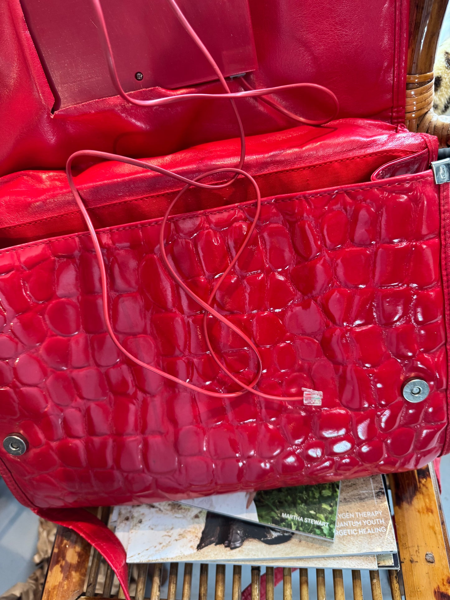 Vintage 1970s working (landline) red patent telephone handbag with top handle and crossbody strap.