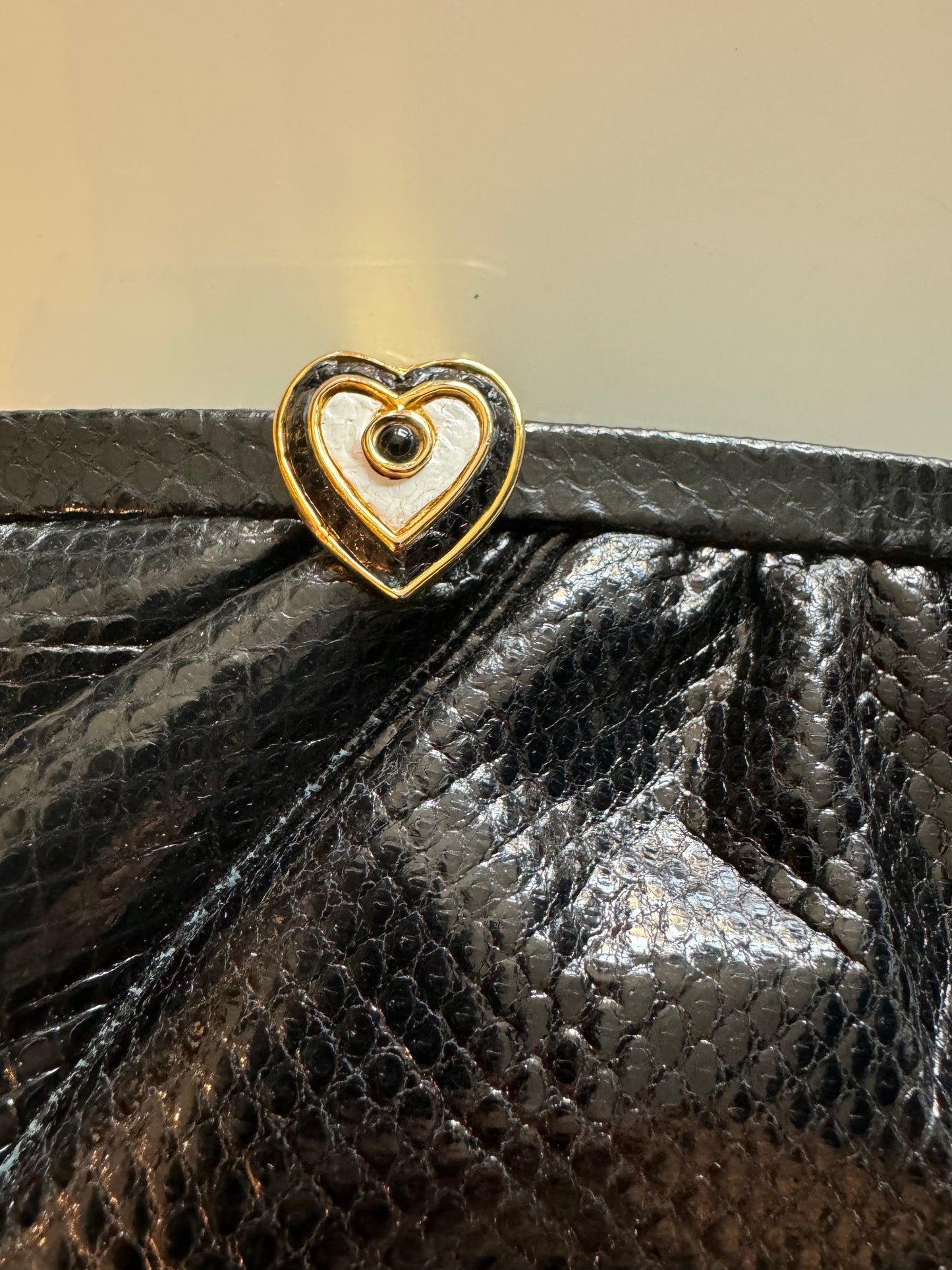 Fabulous Black Judith Leiber skin clutch with gold chain and heart hardware