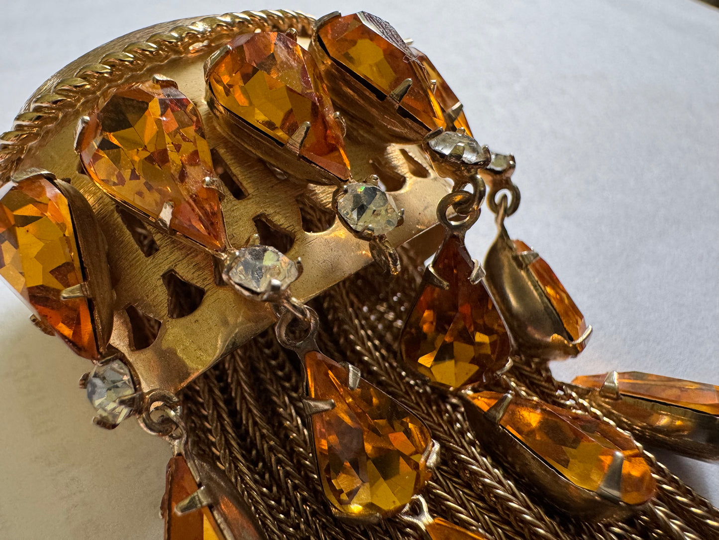 Joseff of Hollywood gold brooch with domed top and cascades of 13 prong set large citrine glass teardrops and 5 round white glass rhinestones w/ tassels.Unsigned Joseff of Hollywood was created for a specific actress for a specific film.