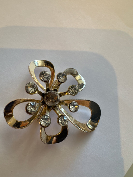 Mini gold tone with rhinestone flower shaped brooch