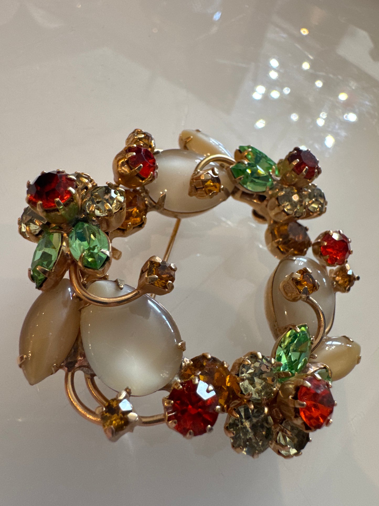 Stunning 1950s wreath brooch with milk, glass, moonstones, and layered petals made out of colored rhinestones