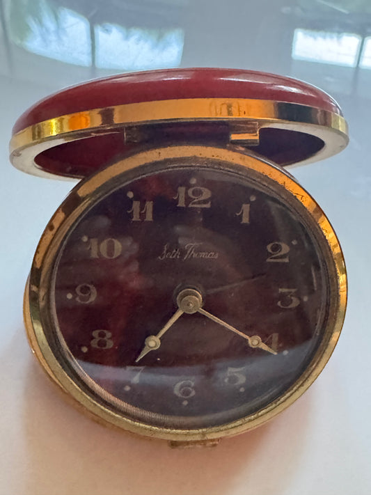 Vintage red round travel clock. Makes great decor piece in a bookshelf