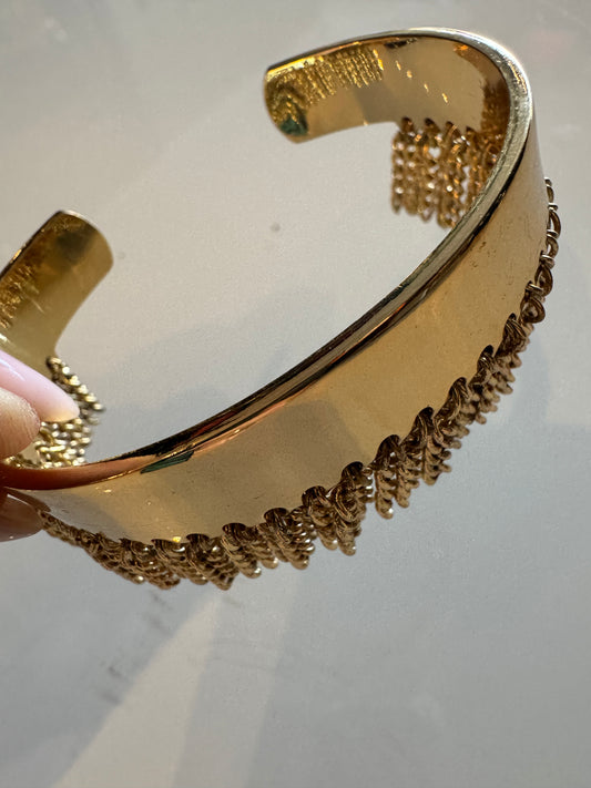 Gold tone adjustable bracelet with gold fringe detail