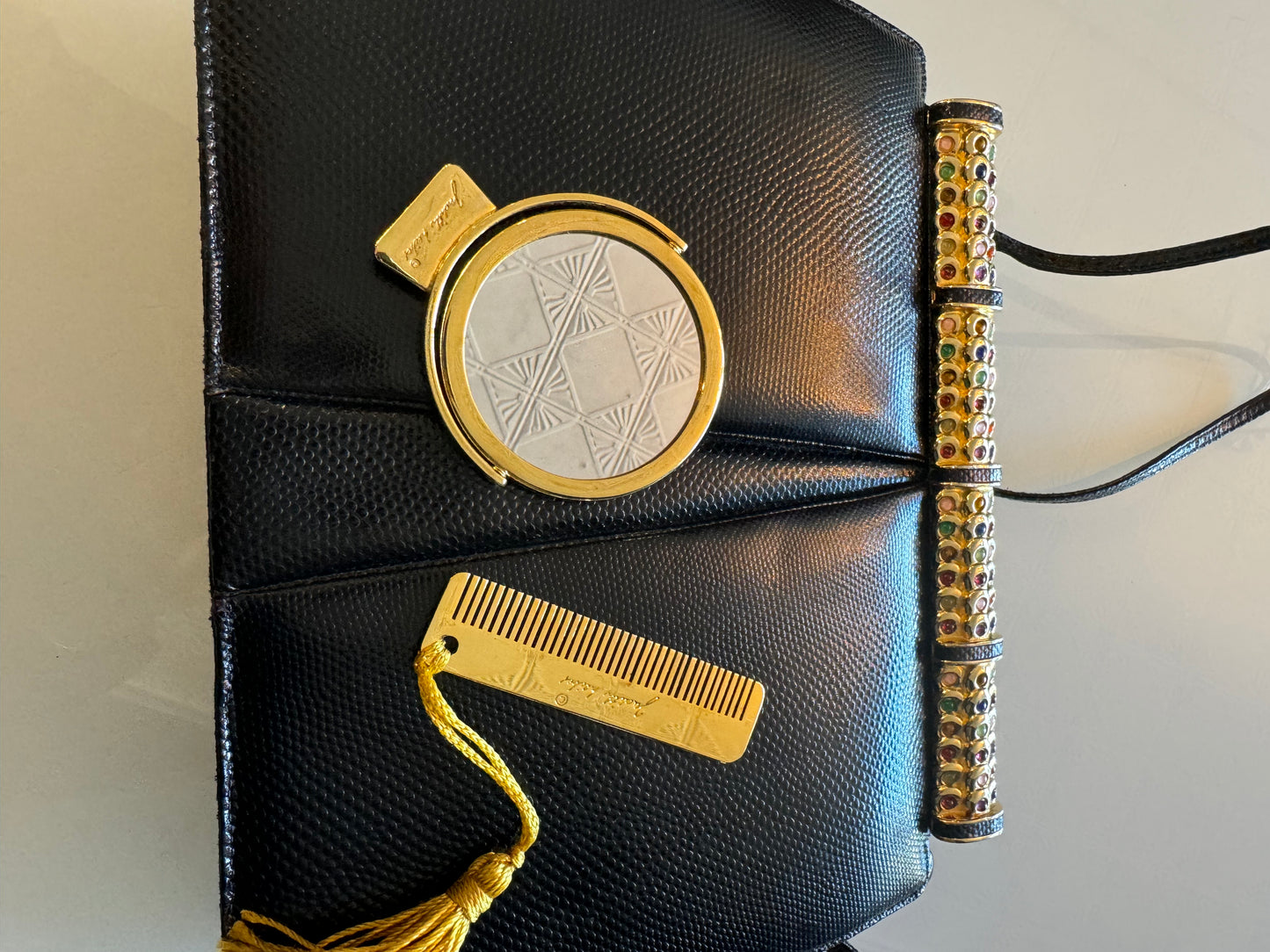 Vintage black snake Judith Leiber with jewel top, convertible clutch strap, original mirror and comb